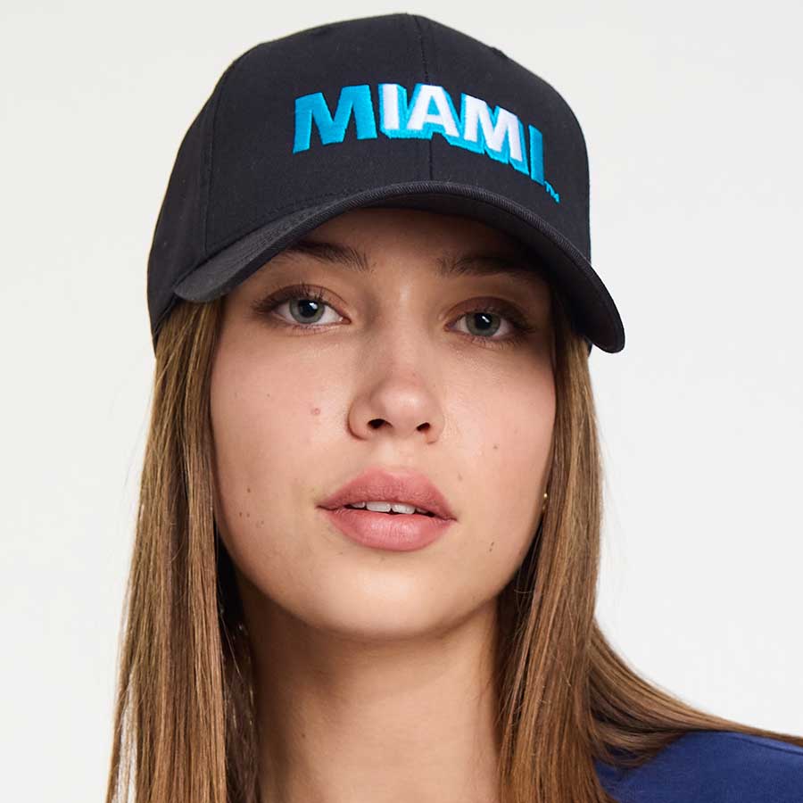 Woman wearing the black Lincoln Road Miami cap, side view