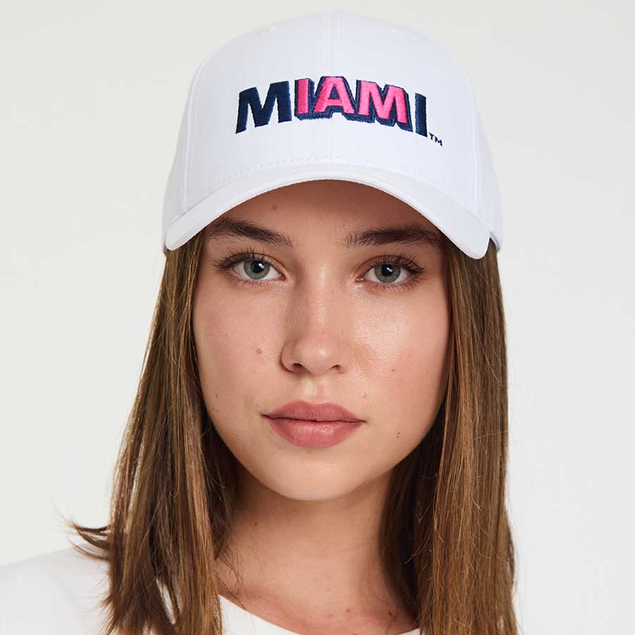 Woman wearing the white Lincoln Road Miami cap, adjustable one size