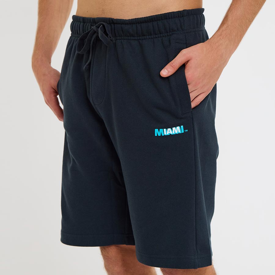 Man wearing the black Ocean Drive Miami shorts with elastic drawstring waist and side pockets